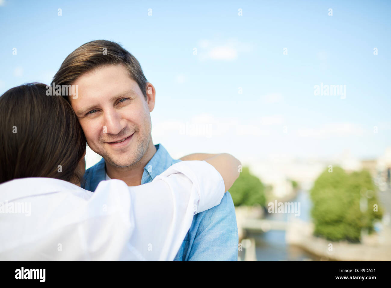 Handsome man hugging girlfriend Stock Photo