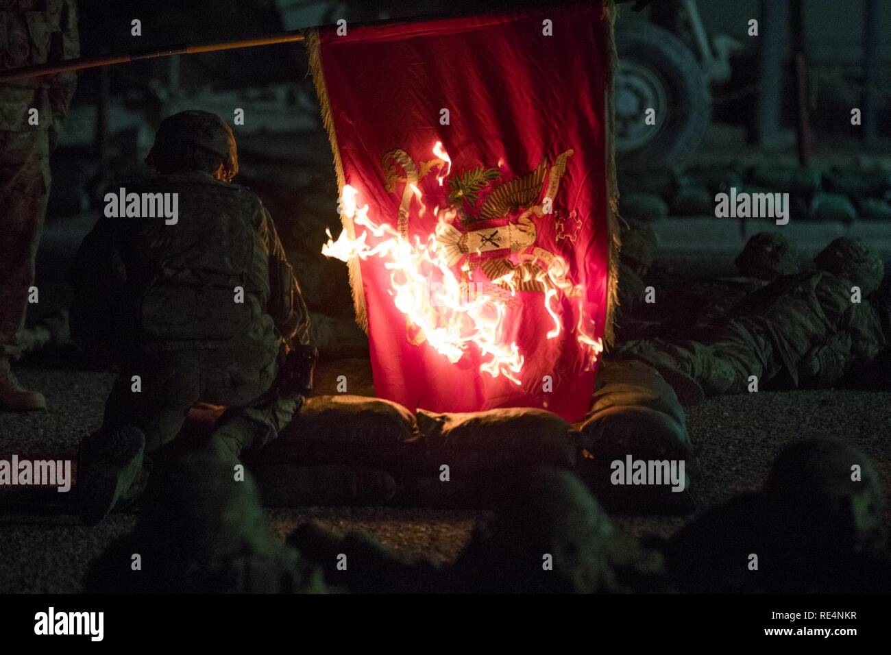 Soldiers from the 2nd Engineer Battalion re-enact the Burning of the Flag at the Battle of Kunu-Ri during the Korean War at Kuwait Naval Base, Nov. 28, 2016. The battalion burns its unit colors each year to remember the battle. On Nov. 30, 1950, the battalion commander ordered the unit flag burned to prevent it from becoming an enemy trophy when the Chinese army overran their position. Stock Photo