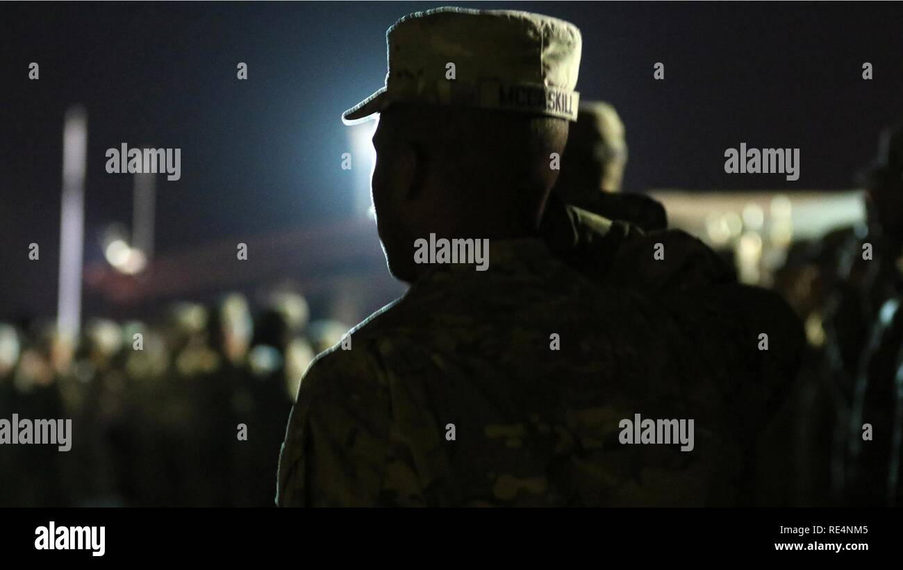 A Soldier salutes the U.S. flag during a Burning of the Colors ceremony Nov. 28, 2016 by the 2nd Engineer Battalion at Kuwait Naval Base. The battalion remembers its fallen during the Korean War each year by burning its flag, recalling the Battle of Kunu-Ri when the battalion commander was forced to destroy equipment and burn its flag to avoid its capture by the Chinese army. Stock Photo