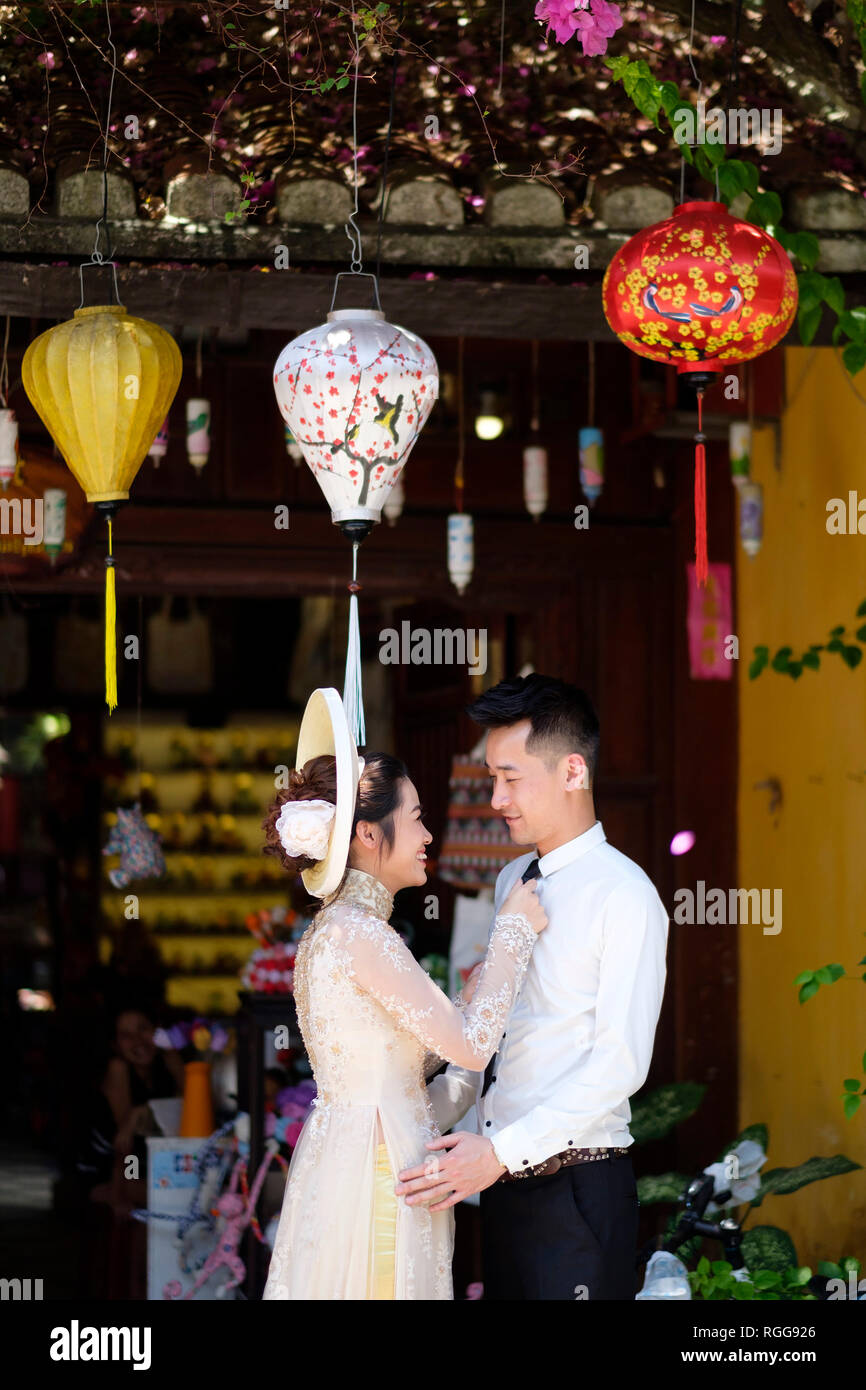 Vietnamese couple having a romantic moment in old town Hoi An, Vietnam Stock Photo