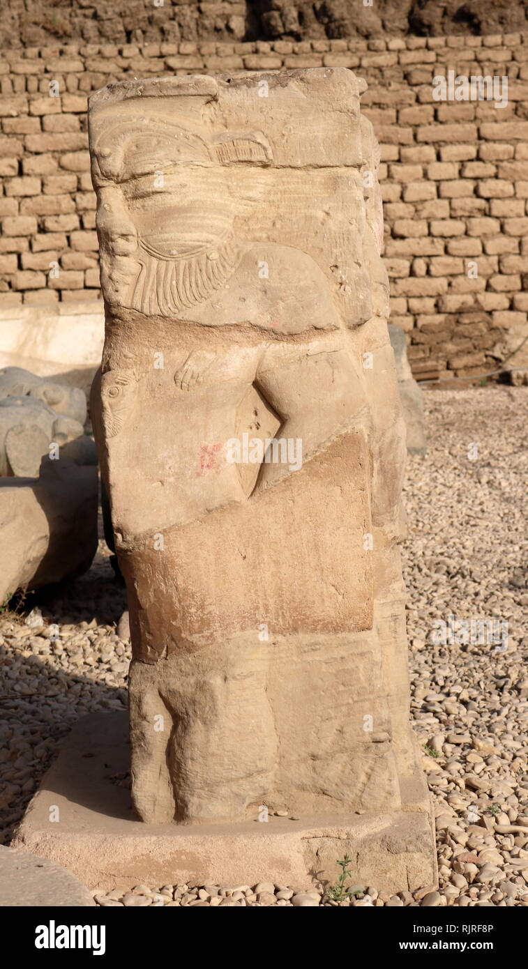 Relief sculpture of the Egyptian God, Bes in the forecourt of the Hathor Temple at Dendera. The dwarf-like god was seen as the protector of pregnant women, new-born babies and the family. The relief dates to the Ptolemaic-Roman period Stock Photo