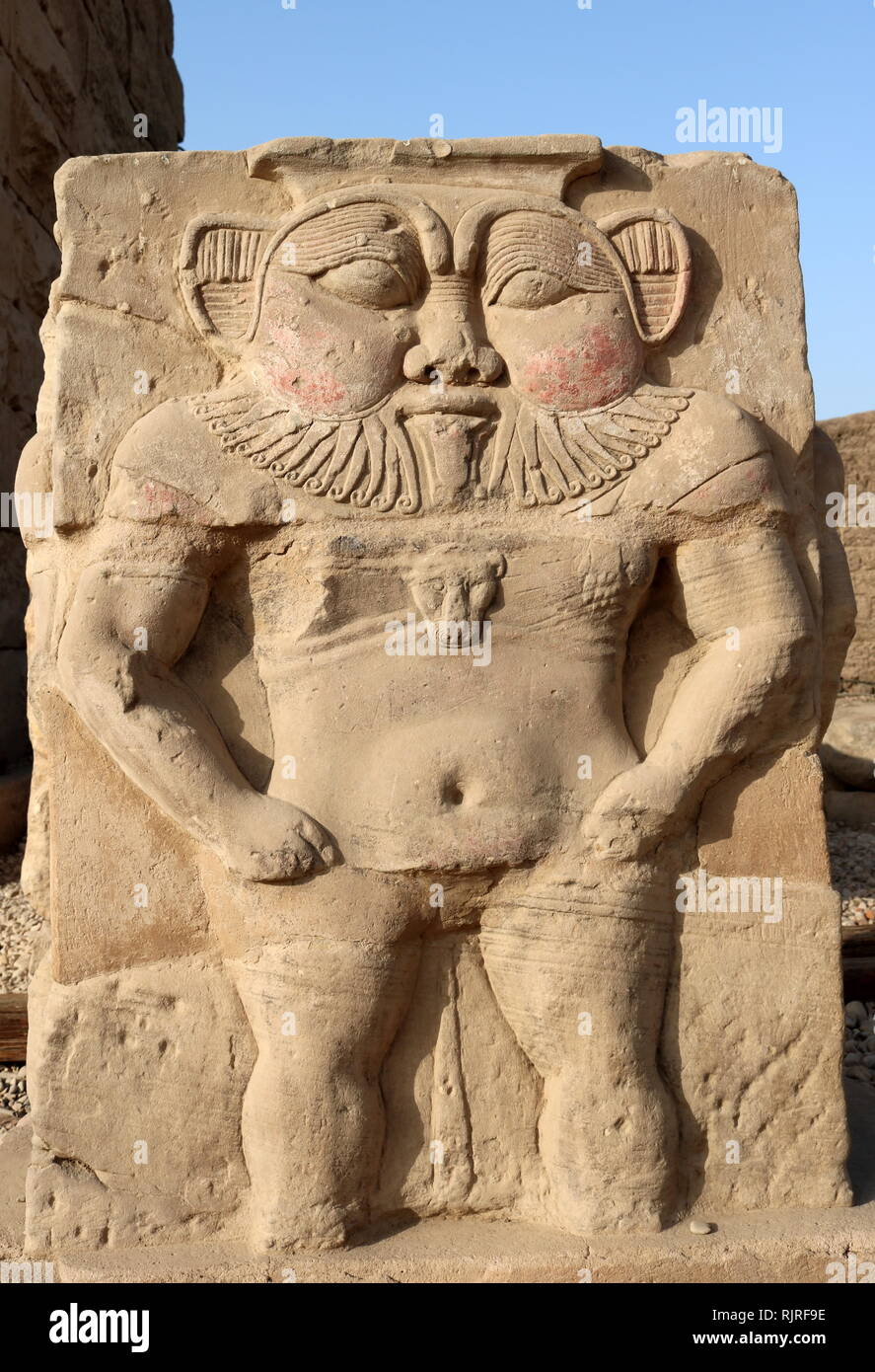 Relief sculpture of the Egyptian God, Bes in the forecourt of the Hathor Temple at Dendera. The dwarf-like god was seen as the protector of pregnant women, new-born babies and the family. The relief dates to the Ptolemaic-Roman period Stock Photo