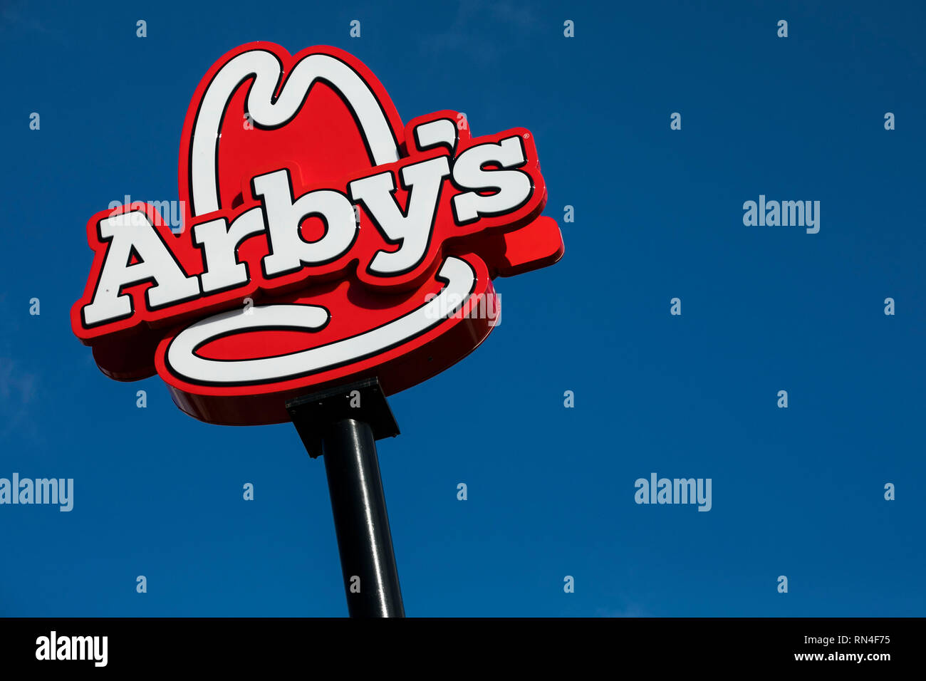 A logo sign outside of a Arby's restaurant location in Martinsburg, West Virginia on February 13, 2019. Stock Photo