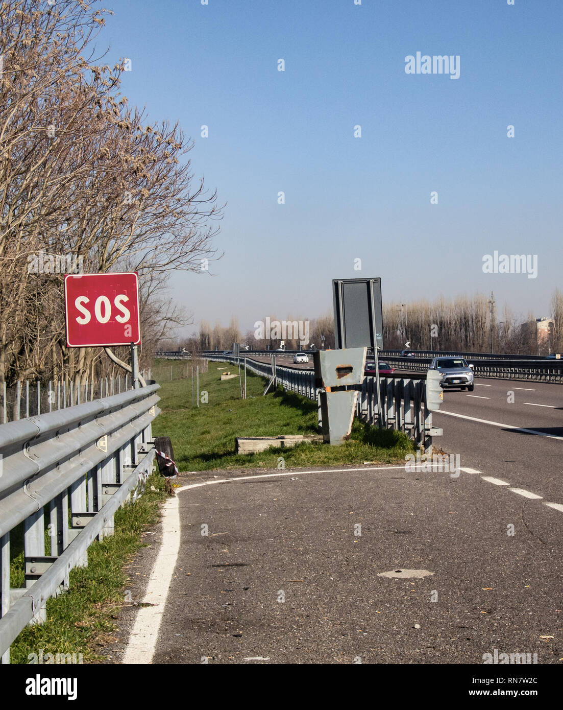 Emergency pitch indicated by a red sign reading SOS and hidden speed detector Stock Photo