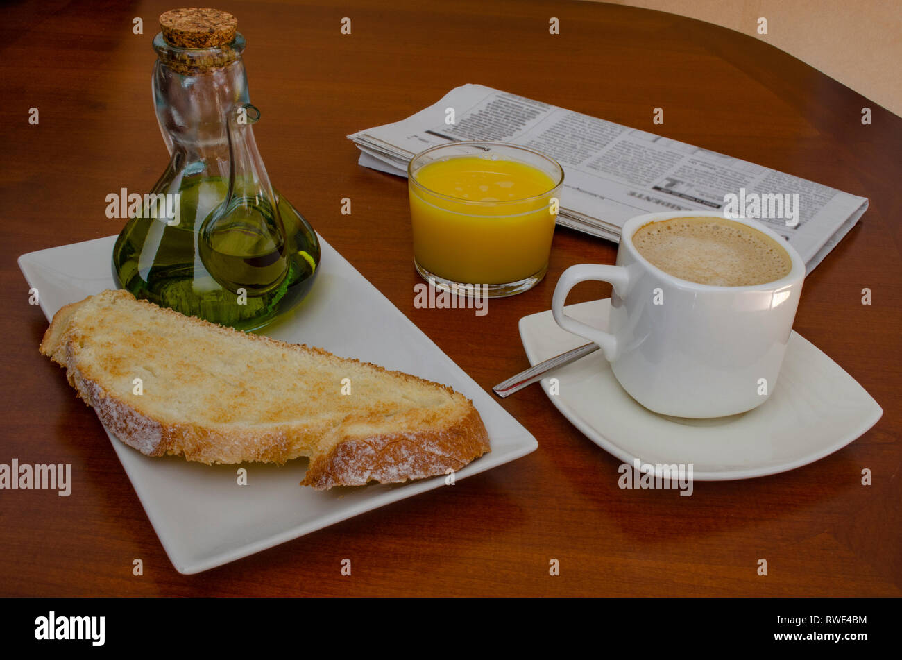 Traditional spanish breakfast coffee with tost and olive oil and orange juice, on a wooden table Stock Photo