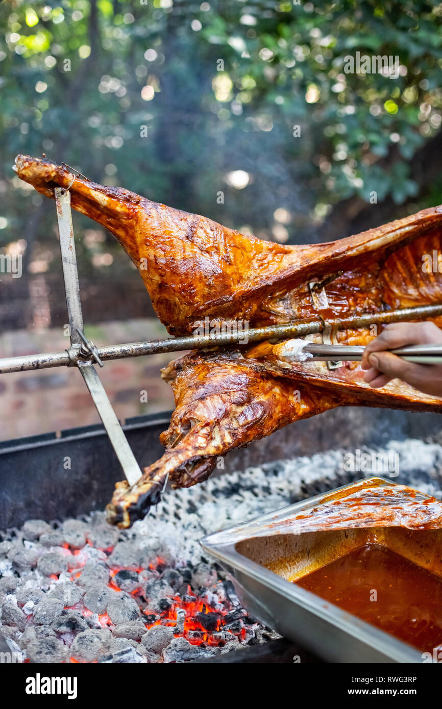 Lamb on the spit. Lamb being cooked on open fire. Stock Photo