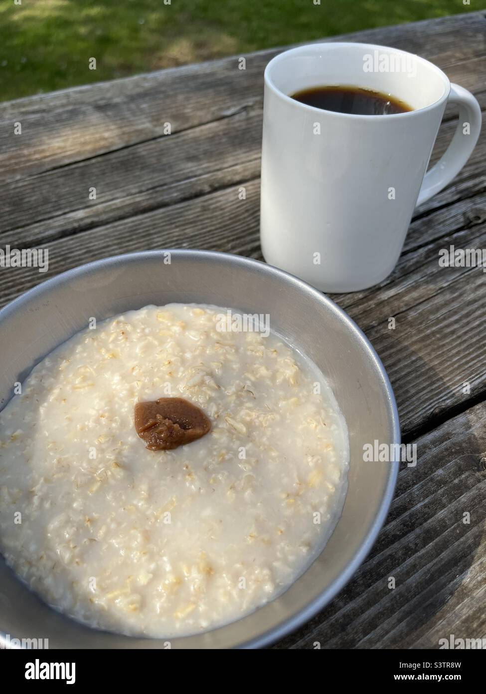 Camp food - coffee and porridge with umeboshi paste Stock Photo