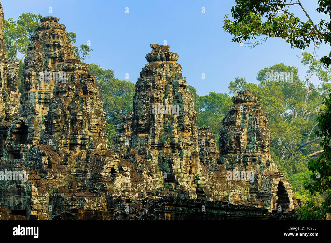 Towers of the famous Bayon, last temple built by King Jayavarman VII in Angkor Thom walled city; Angkor, Siem Reap, Cambodia. Stock Photo