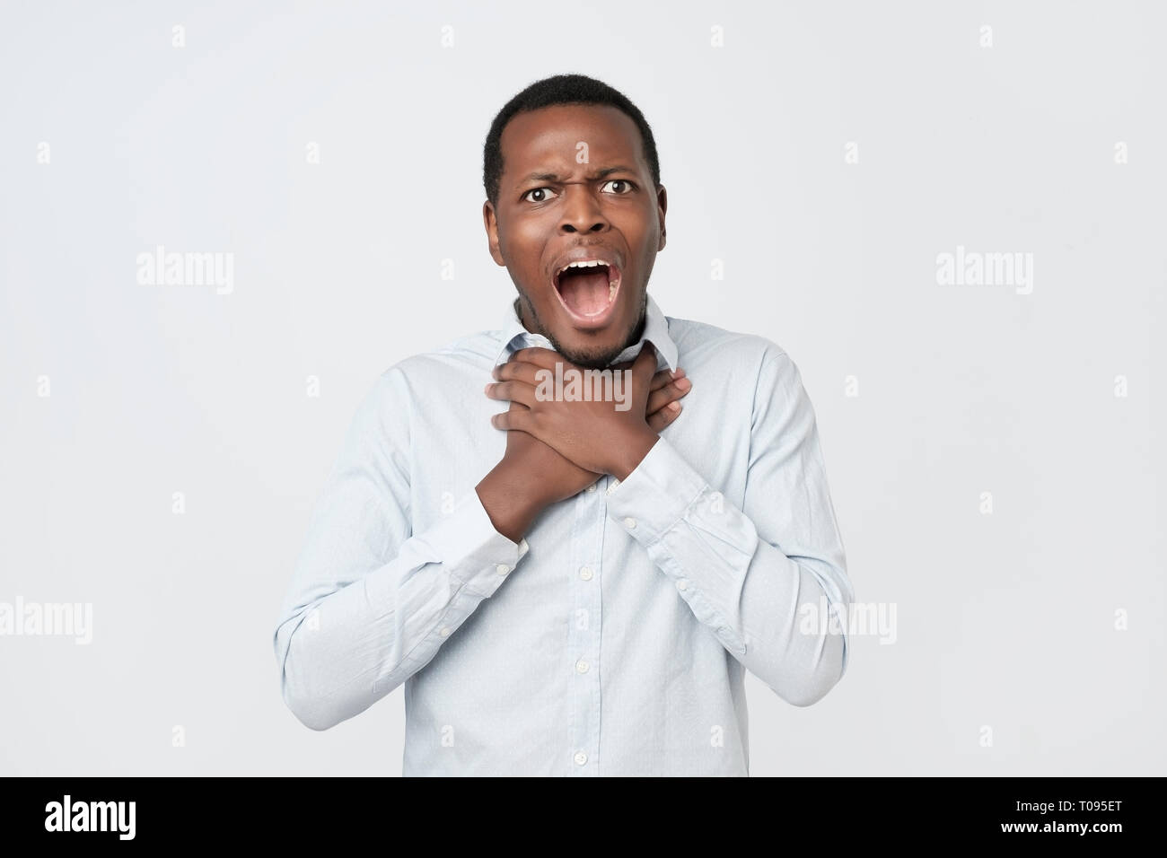 Young african man having asthma attack or choking can not breath suffering from respiration problems Stock Photo