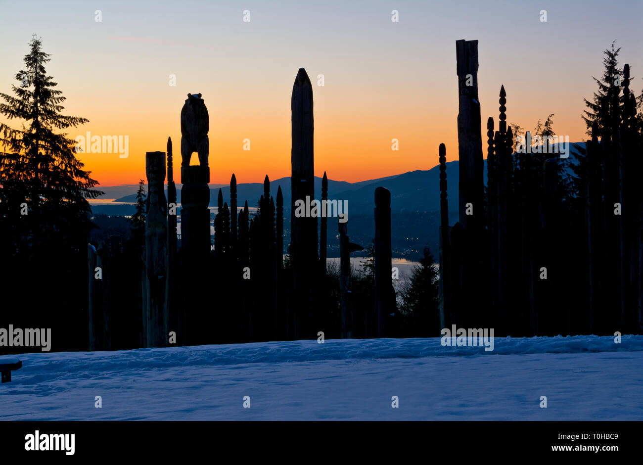 Burnaby Mountain Park in Winter.  'Playground of the Gods' Japanese Ainu totem carvings sculptures, at sunset in Burnaby, British Columbia, Canada. Stock Photo