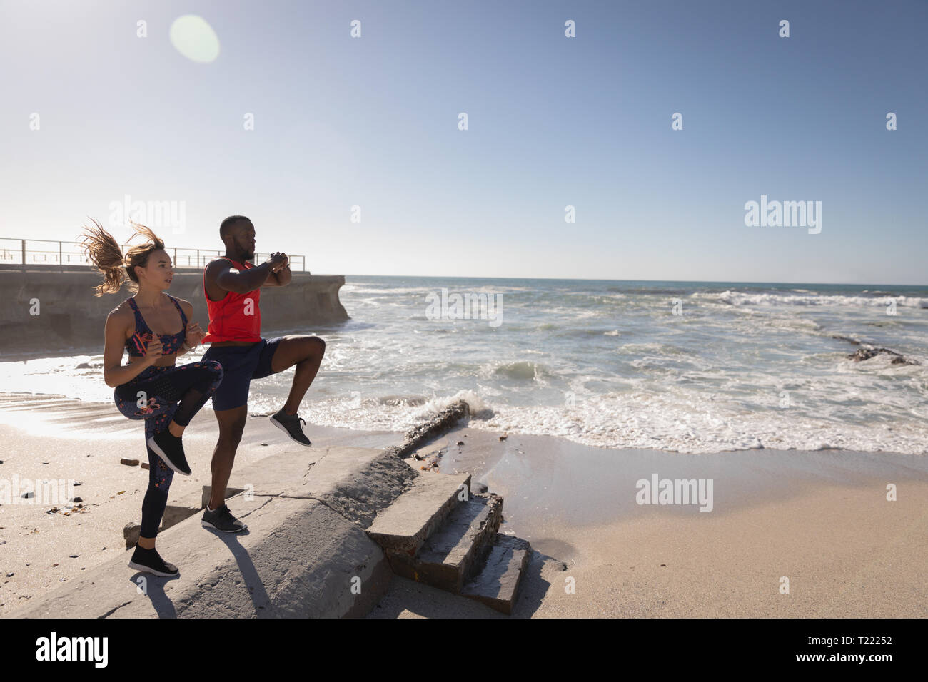 Couple doing spot jogging at beach Stock Photo