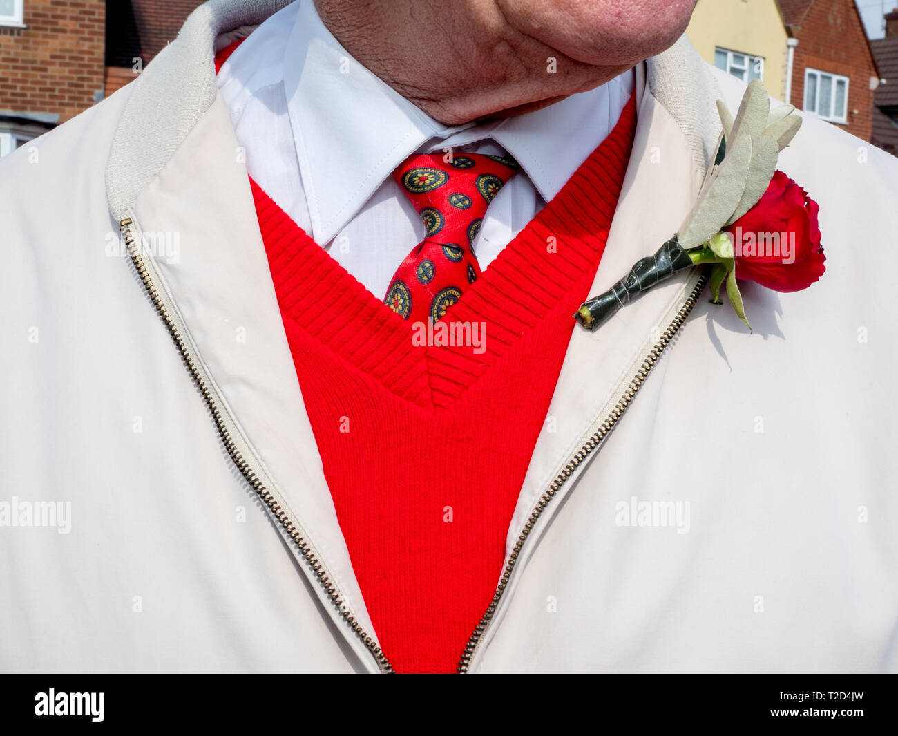 A man wearing a red rose. Stock Photo