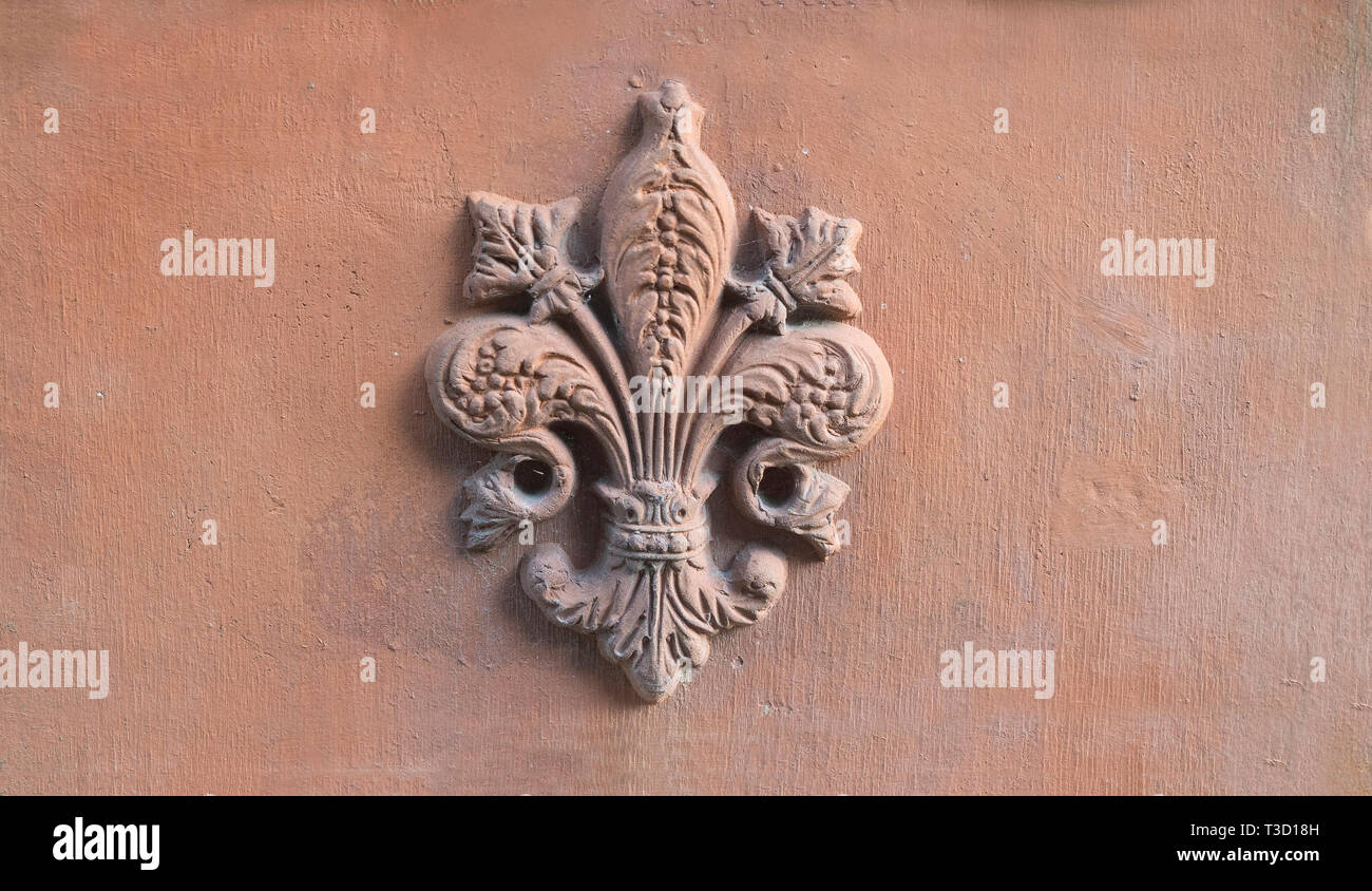 lily symbol of Florence Tuscany printed on a old terracotta tile Stock Photo