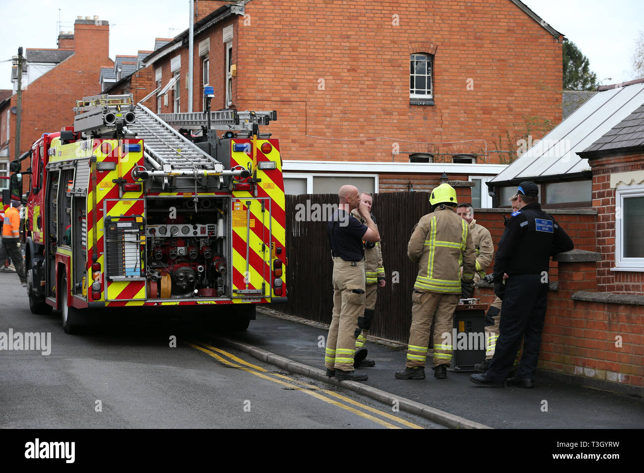 Firefighters at the scene of a house fire on Church Road in the village of Kirkby Muxloe, near Leicester. Stock Photo