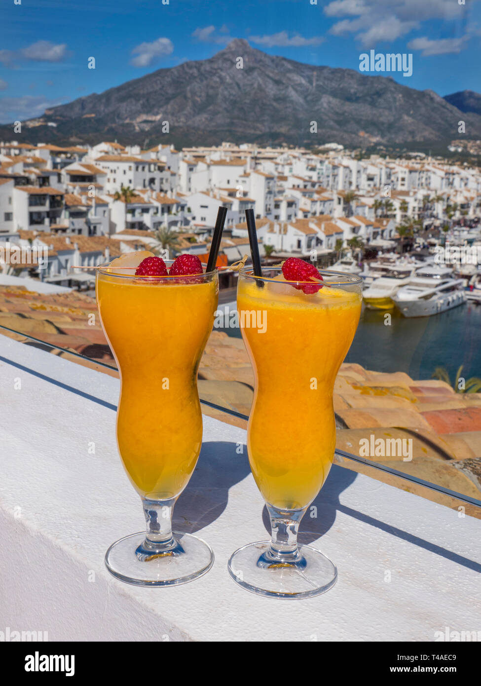 Puerto Banús Marbella fresh natural Spanish orange juice glasses, on luxury alfresco bar Hotel terrace overlooking marina Puerto Banús Marbella Spain Stock Photo