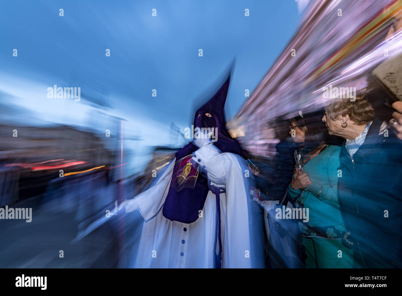 Catholics wearing capirotes, cloaks and hoods, belonging to the Brotherhood of Los Gitanos (gypsies) take part in  procession of penance, through the  Stock Photo