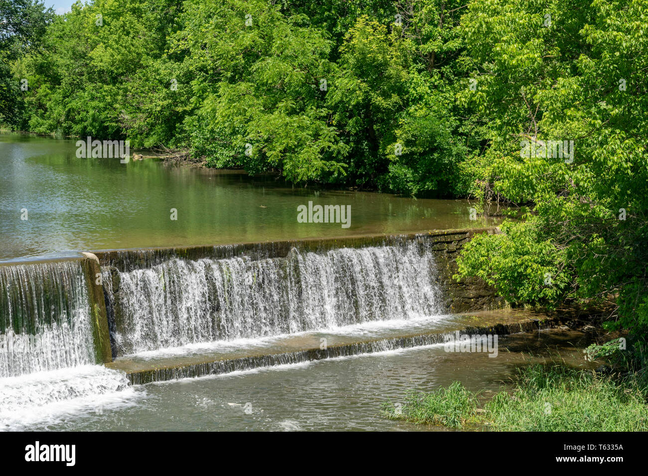 Amish Countryside with a Man Made Waterfall by a Mill Stock Photo