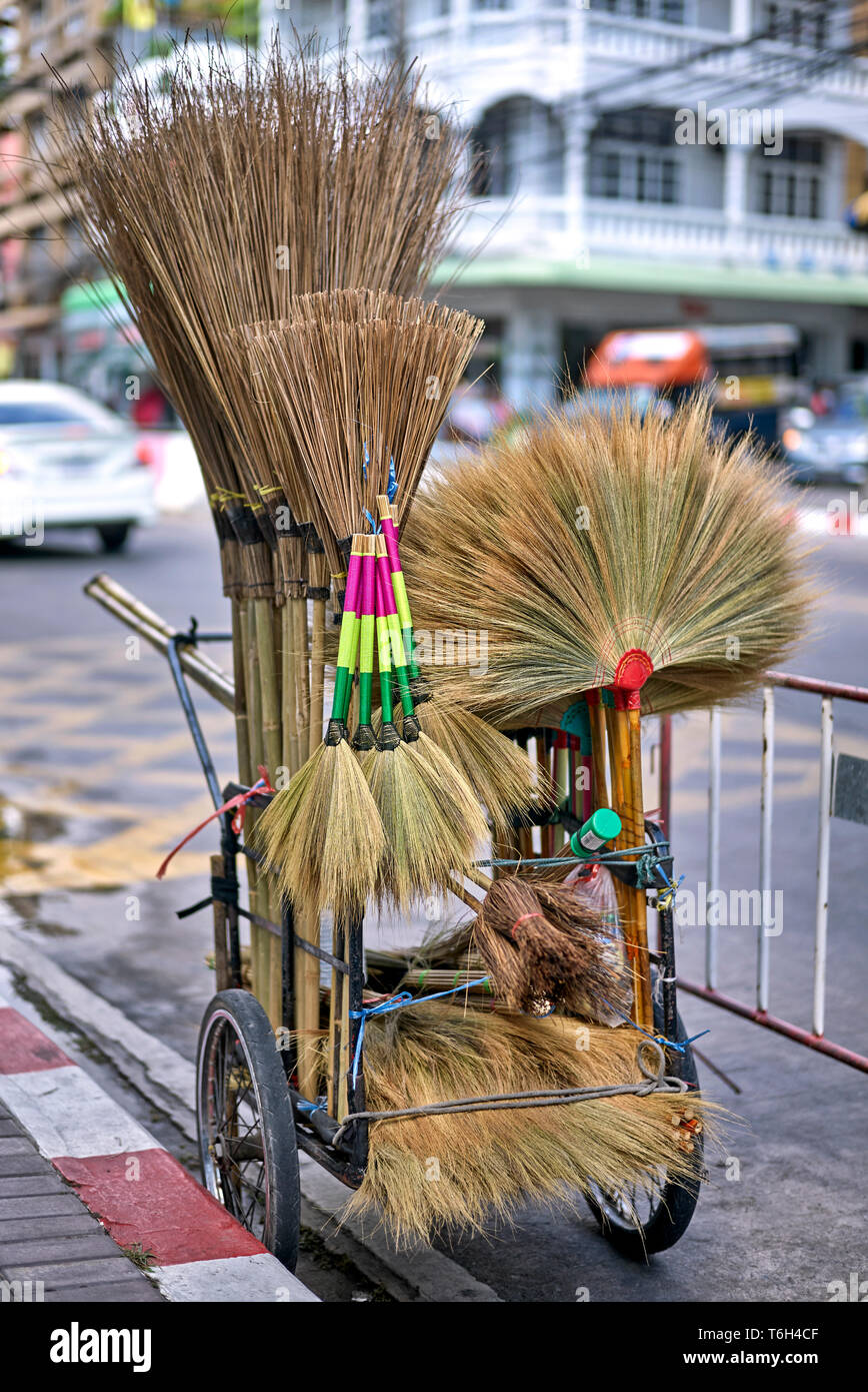 Handmade brooms and brushes for sale on a Thai street vendors cart. Thailand Southeast Asia Stock Photo