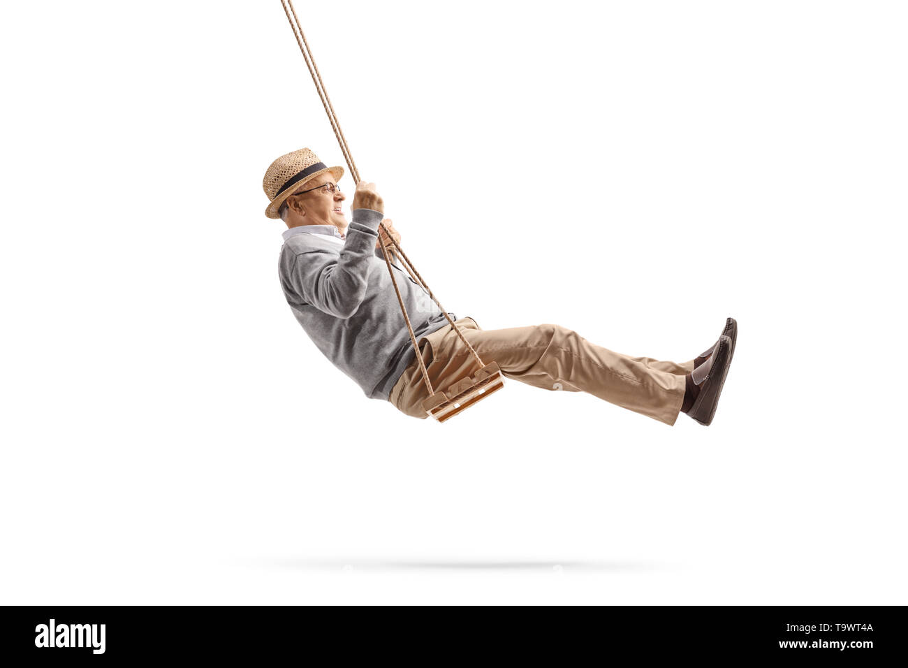 Full length shot of a senior gentleman swinging on a wooden swing isolated on white background Stock Photo