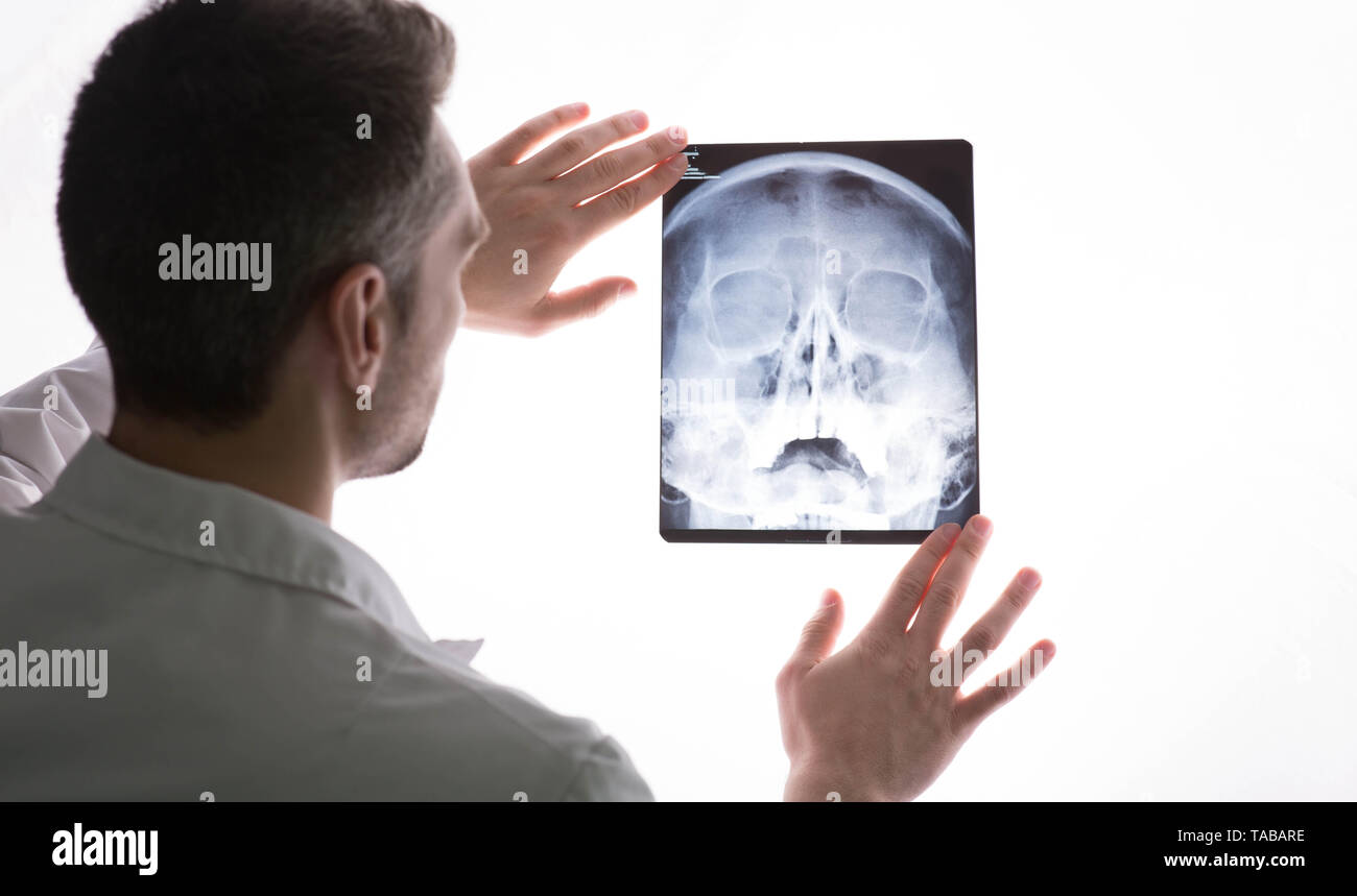 doctor examining patients x-ray and MRI scans. Human Head Sinusitis Stock Photo