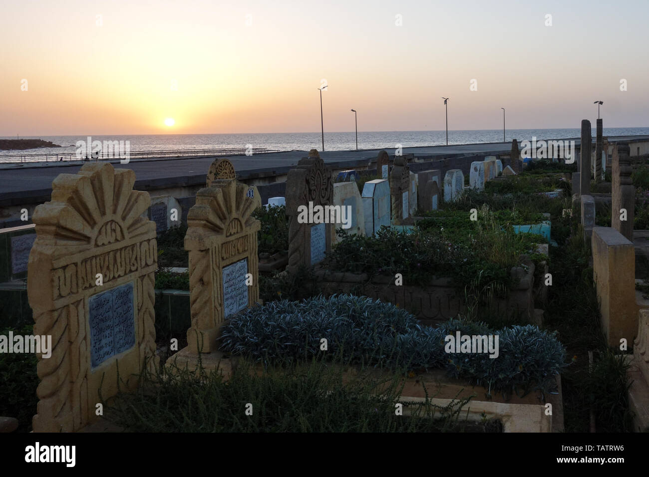 Rabat, Sale, Morocco - March 28th, 2019: Tombstones on a Muslim cemetery during sunset over Sale, Rabat, Morocco Stock Photo