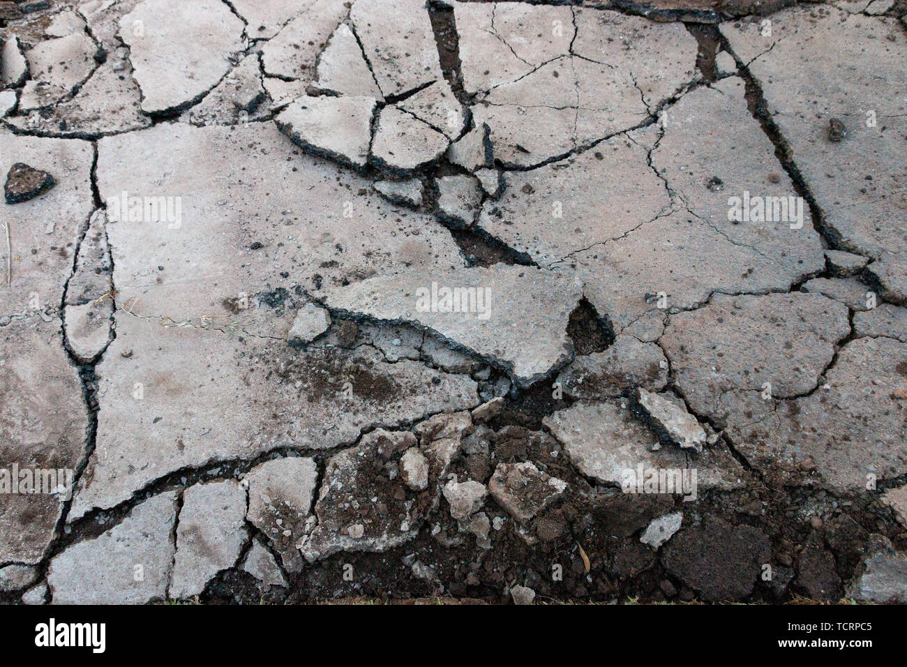 A close up view of an old driveway where the tar has been broken up into differant size pieces so that new tar can be layed. Stock Photo