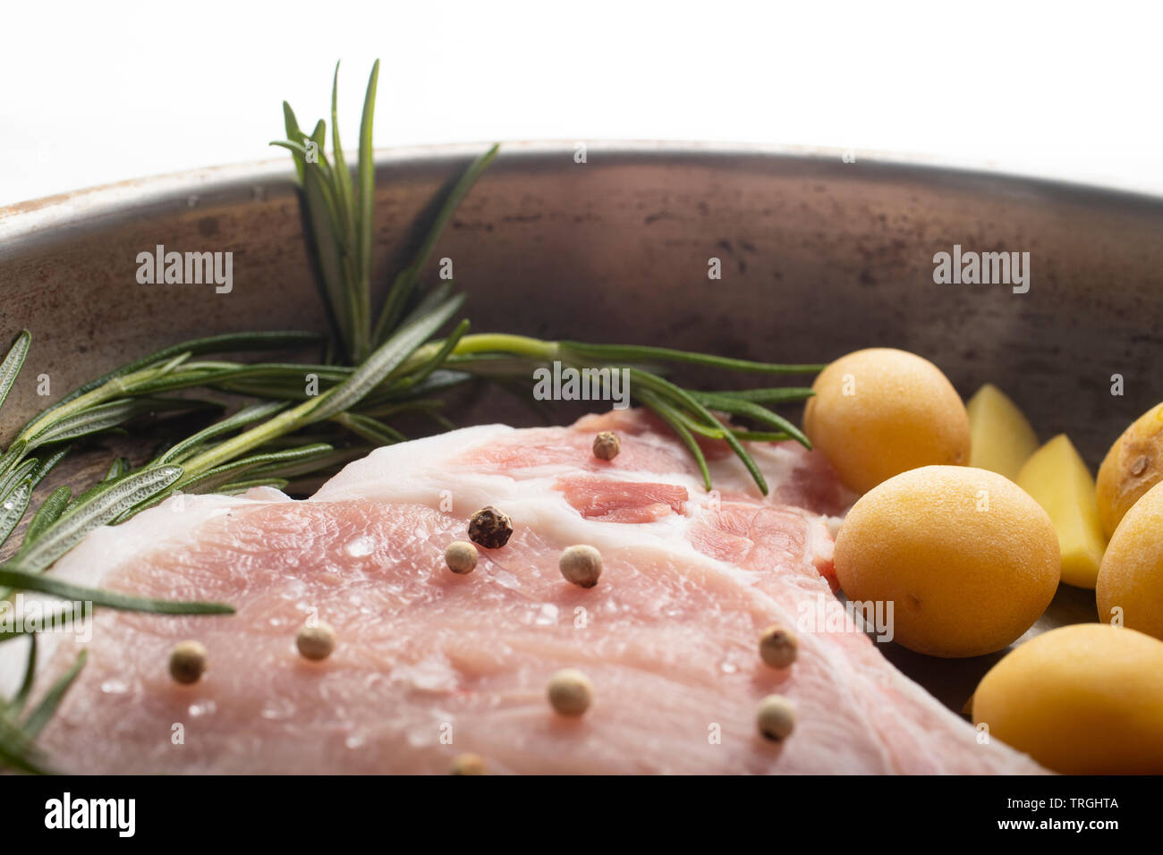 Uncooked meat on a pan with ppotatoes Stock Photo