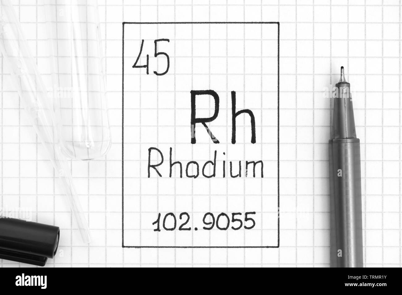 The Periodic table of elements. Handwriting chemical element Rhodium Rh with black pen, test tube and pipette. Close-up. Stock Photo