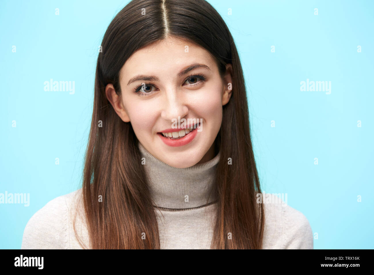 head and shoulder portrait of a young caucasian woman isolated on blue background Stock Photo