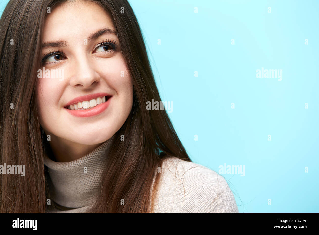 head and shoulder portrait of a young caucasian woman isolated on blue background Stock Photo