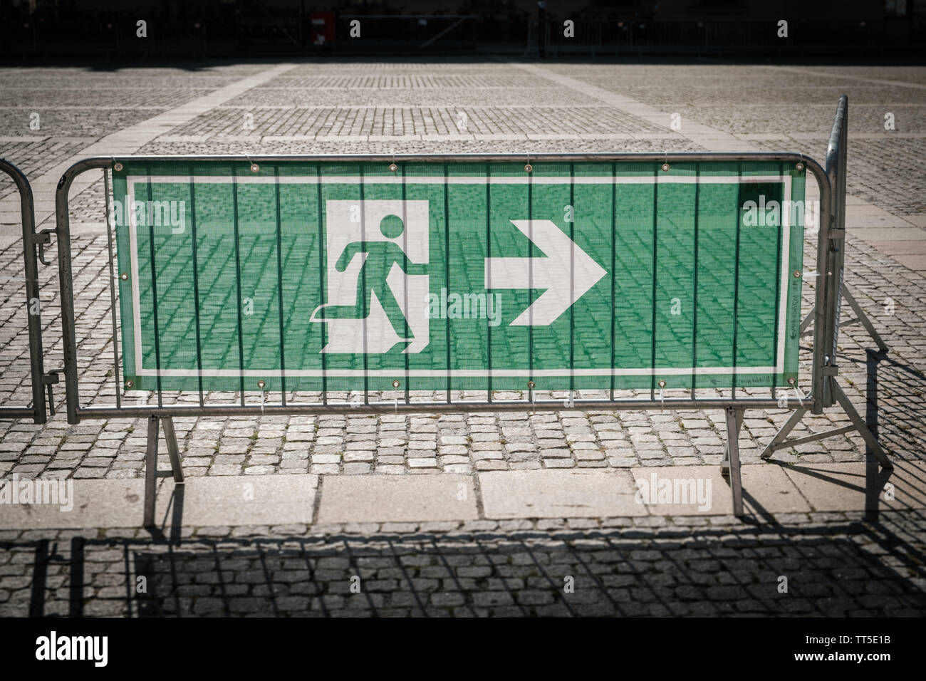 emergency exit sign on security fence for - Stock Photo