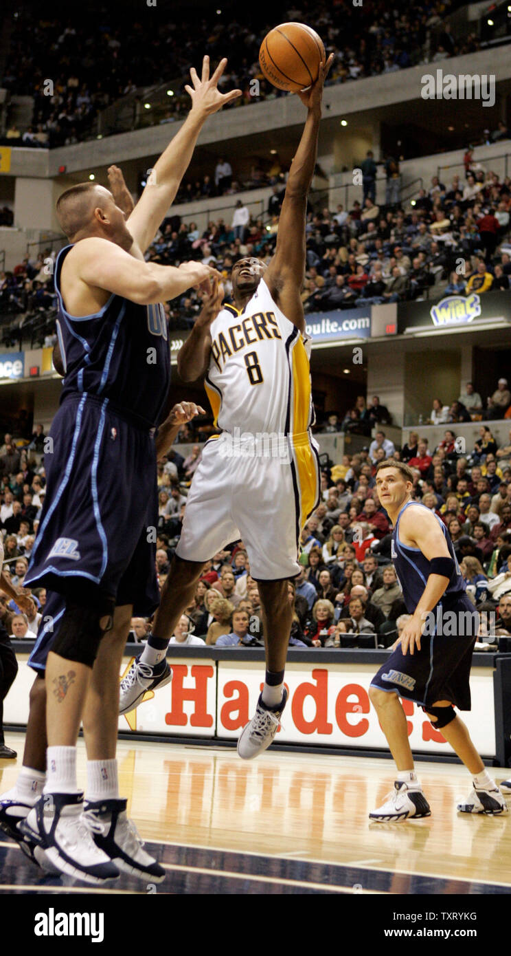 Indiana Pacer Anthony Johnson (8) puts up a shot between Utah Jazz defenders Greg Ostertag (00) and Matt Harpring (15) at Conseco Fieldhouse in Indianapolis, In December 16, 2005. (UPI Photo/Mark Cowan) Stock Photo