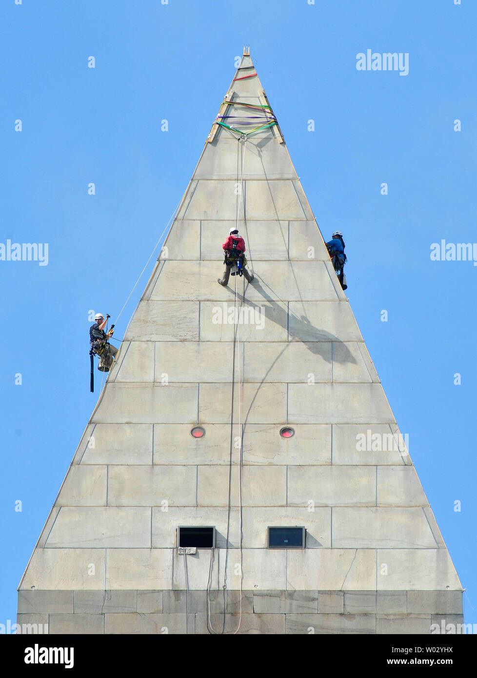 Workers repel the exterior of the Washington Monument as they check for additional damage from last months earthquake, in Washington, D.C. on September 28, 2011. UPI/Kevin Dietsch Stock Photo