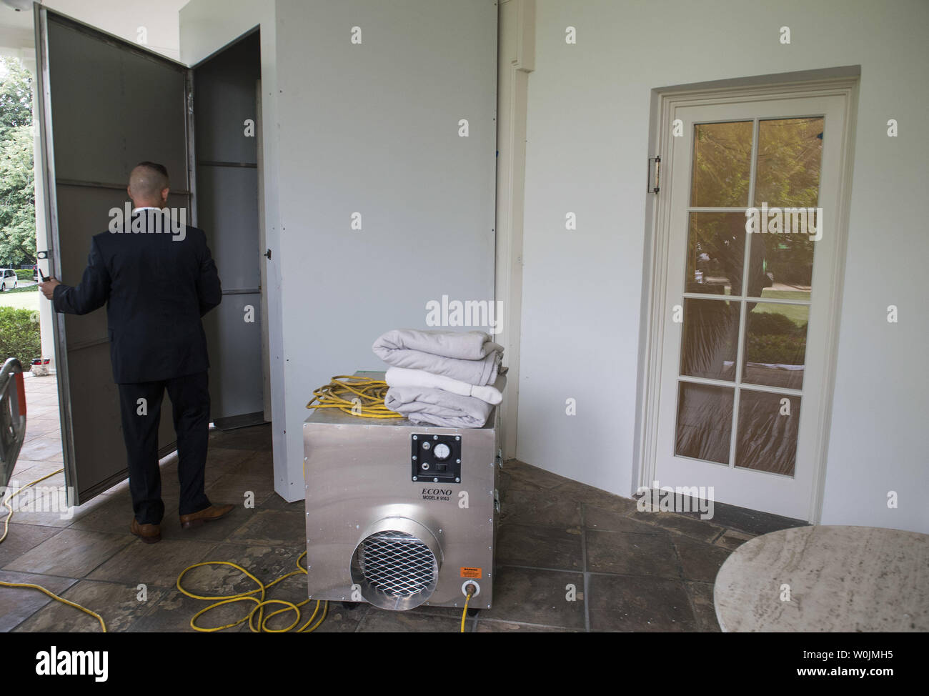 A Secret Service agent opens the temporary door to the Oval Office as renovations continue at the White House, in Washington, D.C. on August 11, 2017. While President Trump is in New Jersey on a 17-day vacation workers are updating and repairing the West Wing, including structural repairs, IT and HVAC improvements and generic cosmetic upgrades. Photo by Kevin Dietsch/UPI Stock Photo