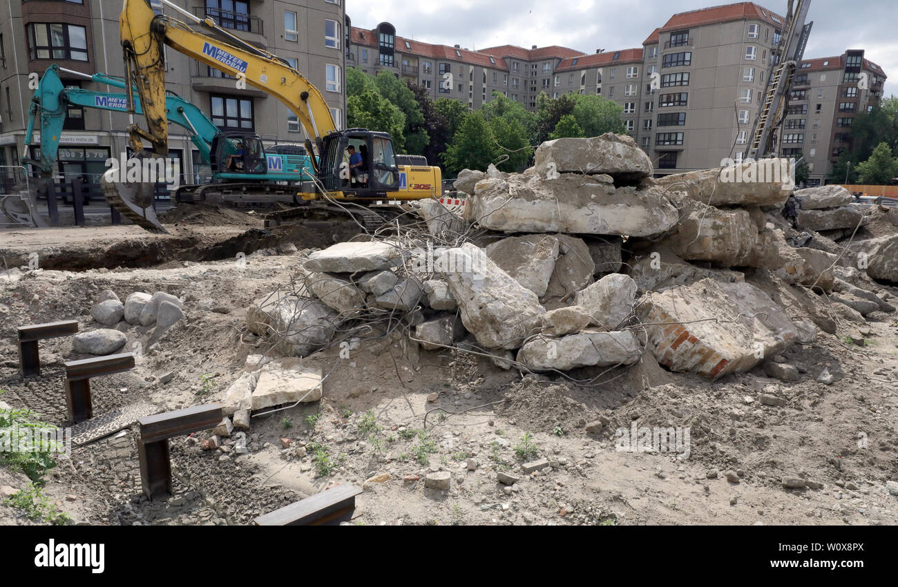 Berlin, Germany. 19th June, 2019. Excavators are digging out the remains of a bunker from the NS era on Behrenstraße in the Mitte district. On this site, where the Reich Ministry of Food and Agriculture and the building of the Reich President once stood, a new building with underground car park is being erected. In the background residential buildings on Wilhelmstraße and Vossstraße, where other ministries and the Reich Chancellery with the Führer bunker were located. Credit: Wolfgang Kumm/dpa/Alamy Live News Stock Photo