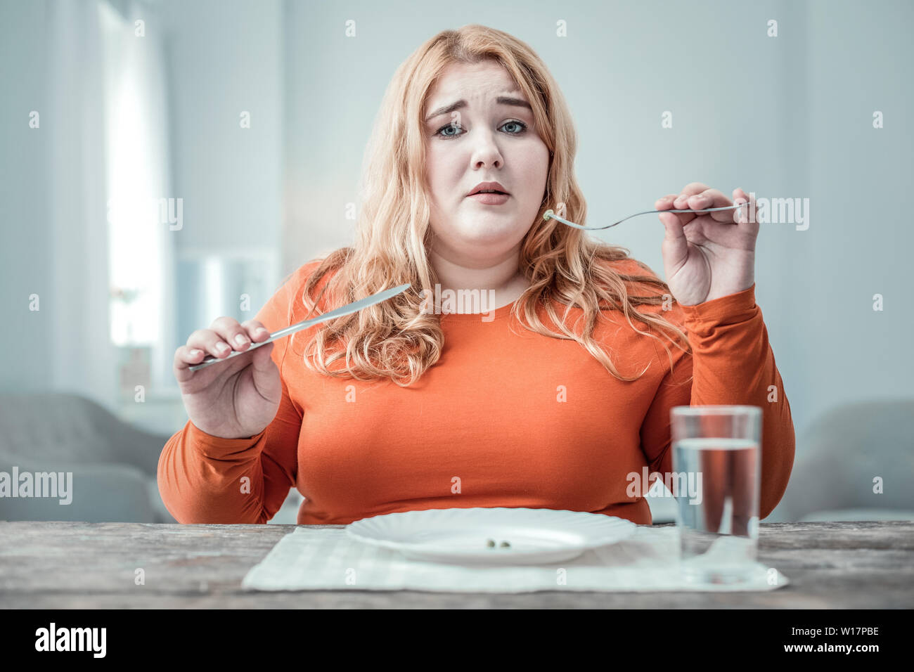 Sad young woman looking straight at camera Stock Photo