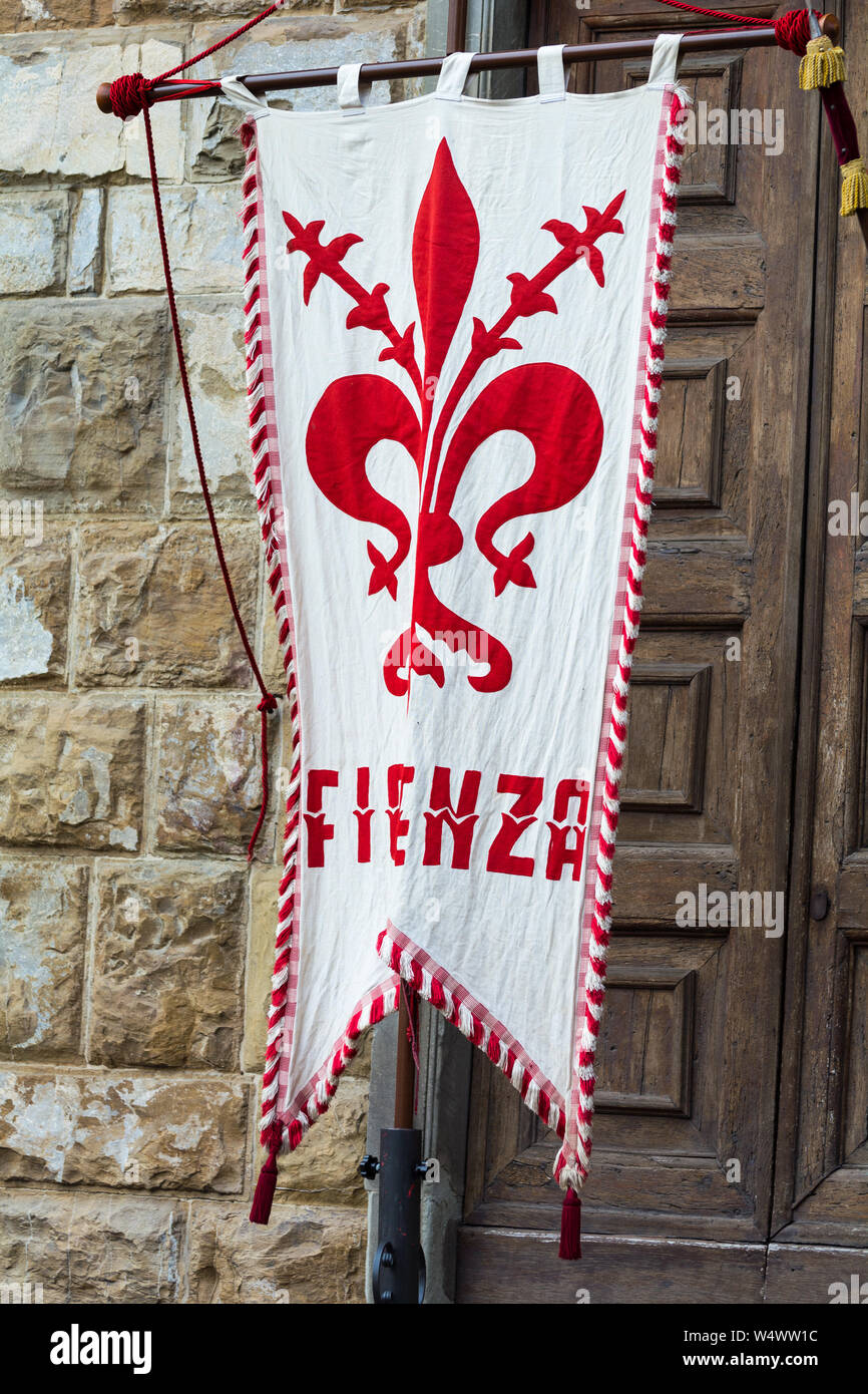 FLORENCE, ITALY - MAY 12, 2019: Traditional Florentine guards with flag posing in front of tourists. Piazza della Signoria in Florence, Italy Stock Photo