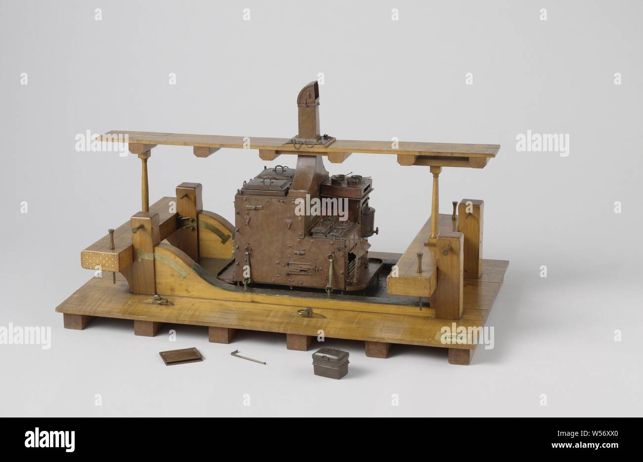 Model of a Ship's Galley, Model of a ship galley on a deck between two bites. The deck is covered with brass at the location of the galley, the chimney protrudes through a part of the deck above it, which is indicated to be the width of three boards and stands on deck struts that run straight through the betting beams. The galley itself, secured with hooks in the betting knees, is entirely made of copper, insides of pans and the like are tinned. It is a very detailed model and can be taken apart. At the front left is a large oven with a layer of stove above it for rectangular pans: the stove Stock Photo