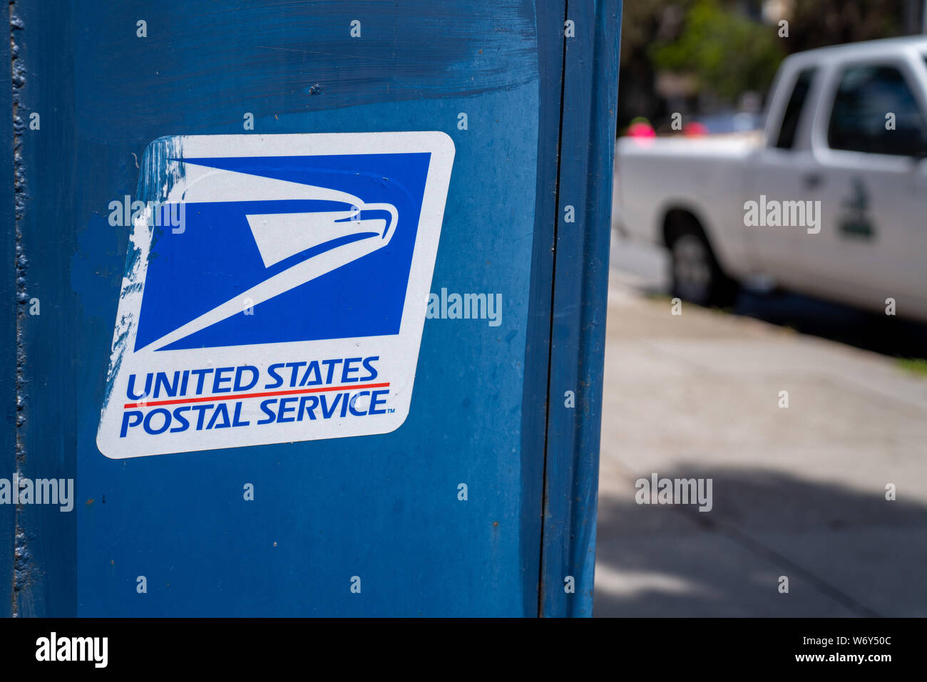 United States Postal Service USPS, logo and on mail box on sidewalk Stock Photo