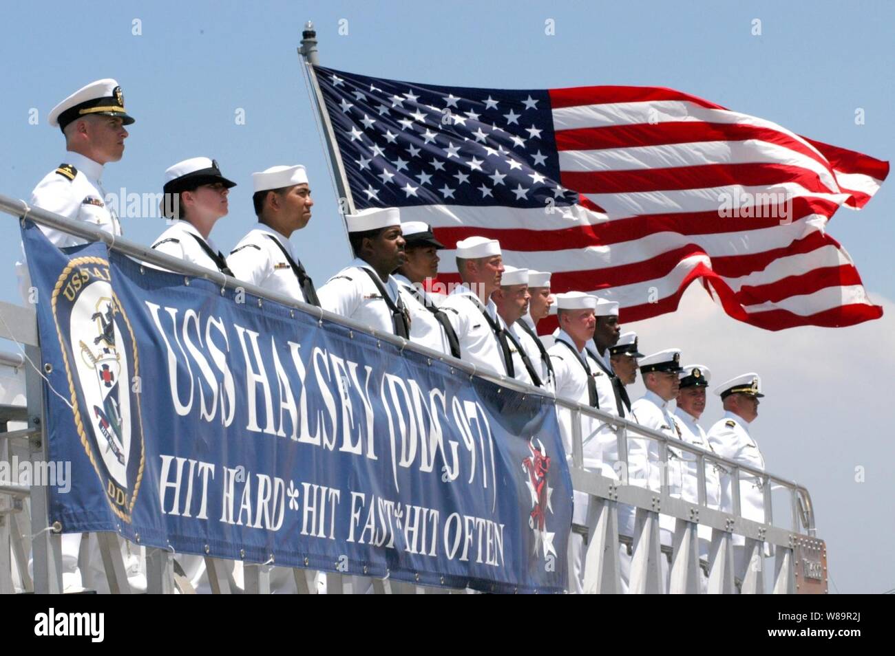 The crew manning the rail of the USS Halsey (DDG 97) stands at parade rest as the Navy's newest Arleigh Burke-class destroyer is commissioned at Naval Air Station North Island, San Diego, Calif., on July 30, 2005.   The destroyer is named for U.S. Naval Academy graduate Fleet Adm. William F.  'Bull' Halsey Jr. who commanded South Pacific Force and South Pacific Area during World War II. Stock Photo