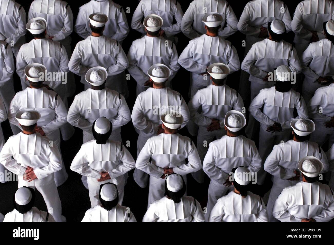 The crew of the aircraft carrier USS John C. Stennis (CVN 74) stand at parade rest during a change of command ceremony on May 5, 2006. Stock Photo