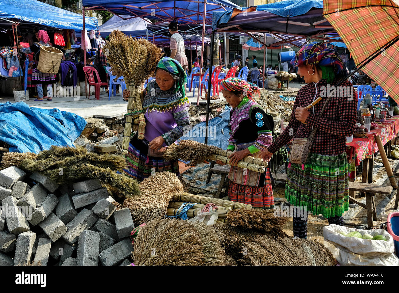 Bac Ha, Vietnam - August 26: Women selling traditional brooms in the market on August 26, 2018 in Bac Ha, Vietnam. Stock Photo