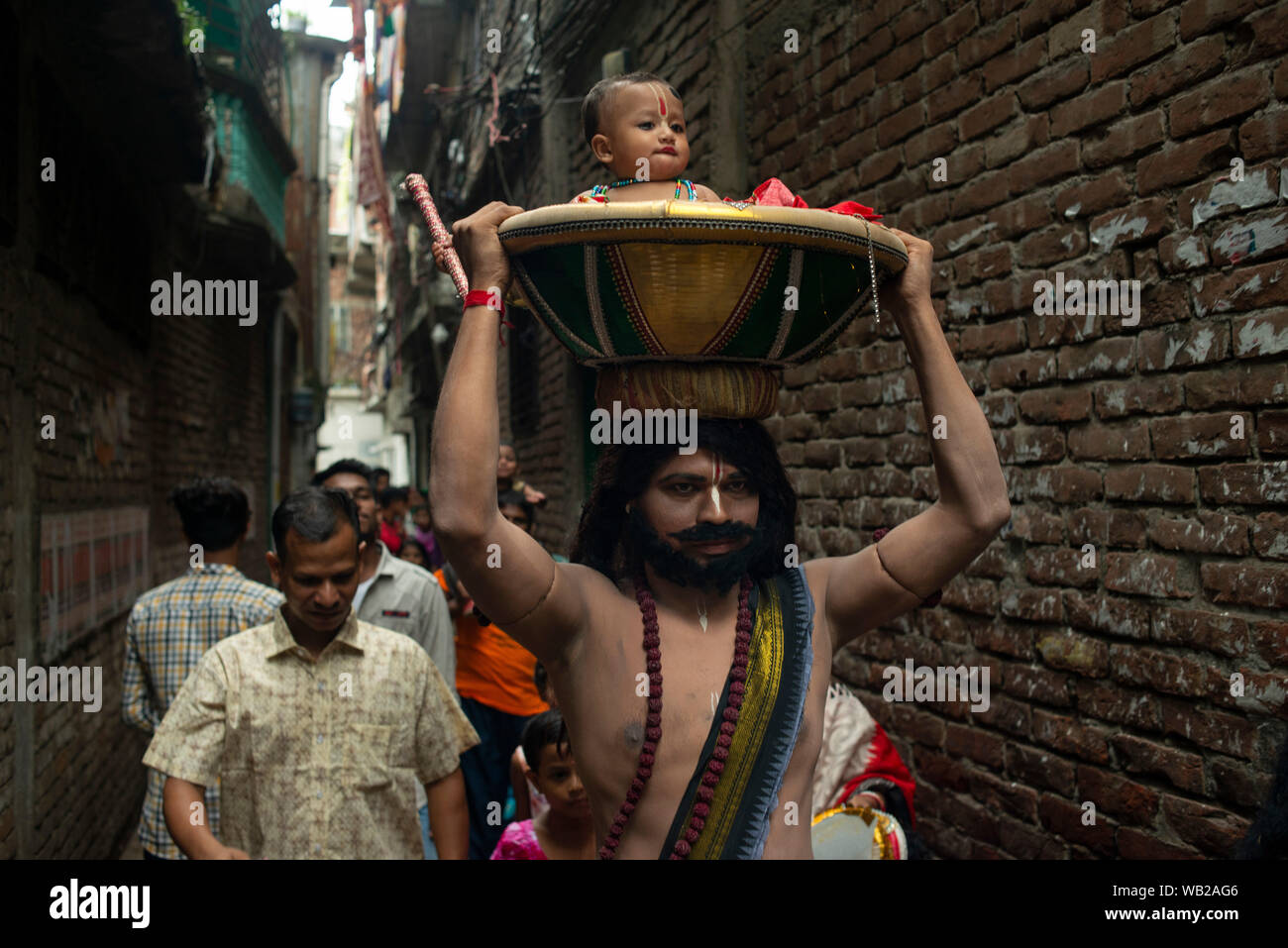 Hindu devotees walk as they participate during the occasion of JanmashtamiFollowers of Hinduism put makeup and dressed as many characters from Ramayana in the occasion of Janmashtami, the birth anniversary of Lord Krishna and arrange rallies and gatherings of people of their community. Stock Photo