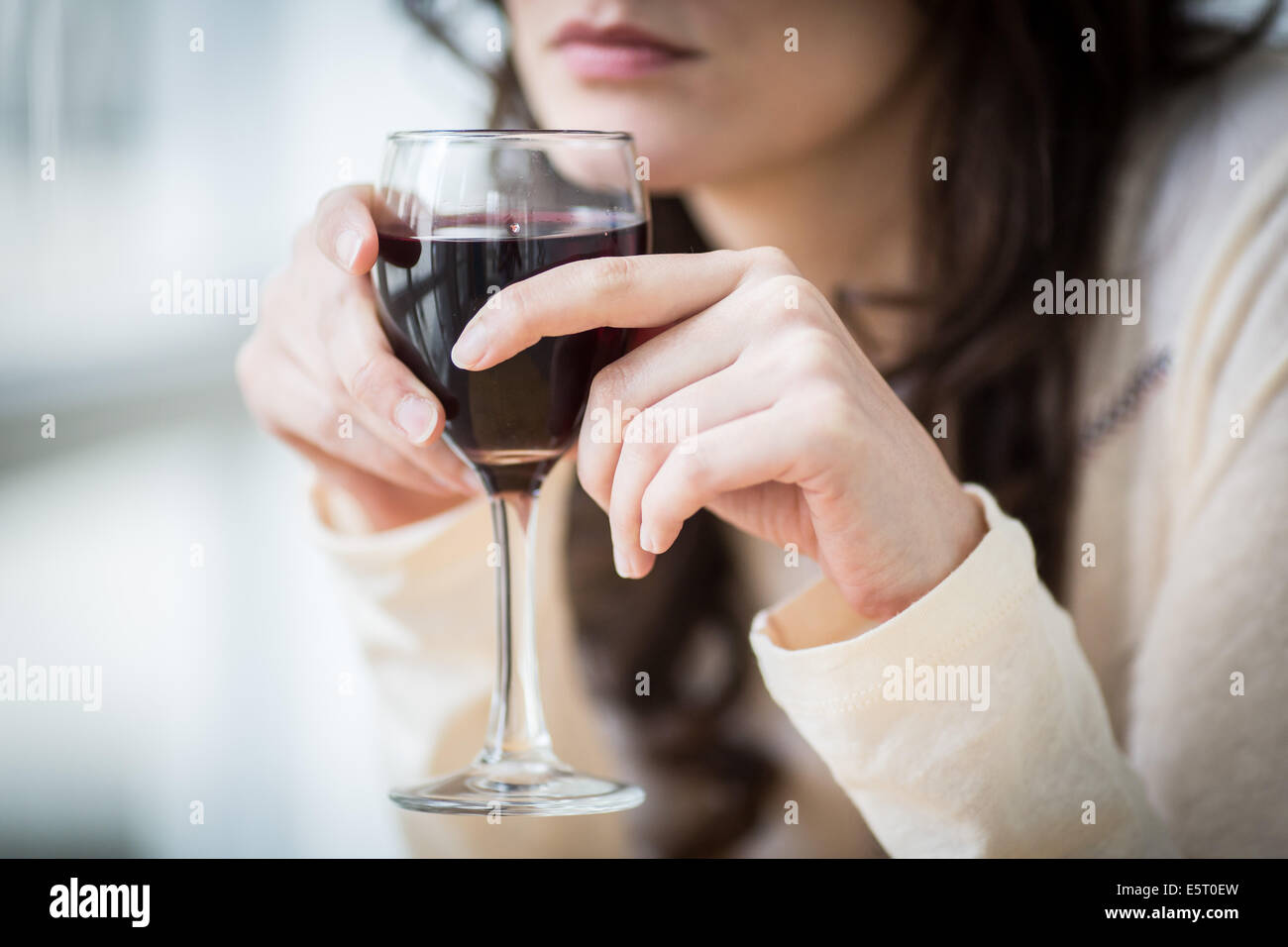 Femme buvant un verre de vin rouge. Banque D'Images