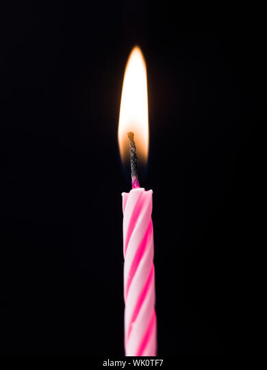 Single Birthday Candle on black background Stock Photo - Alamy