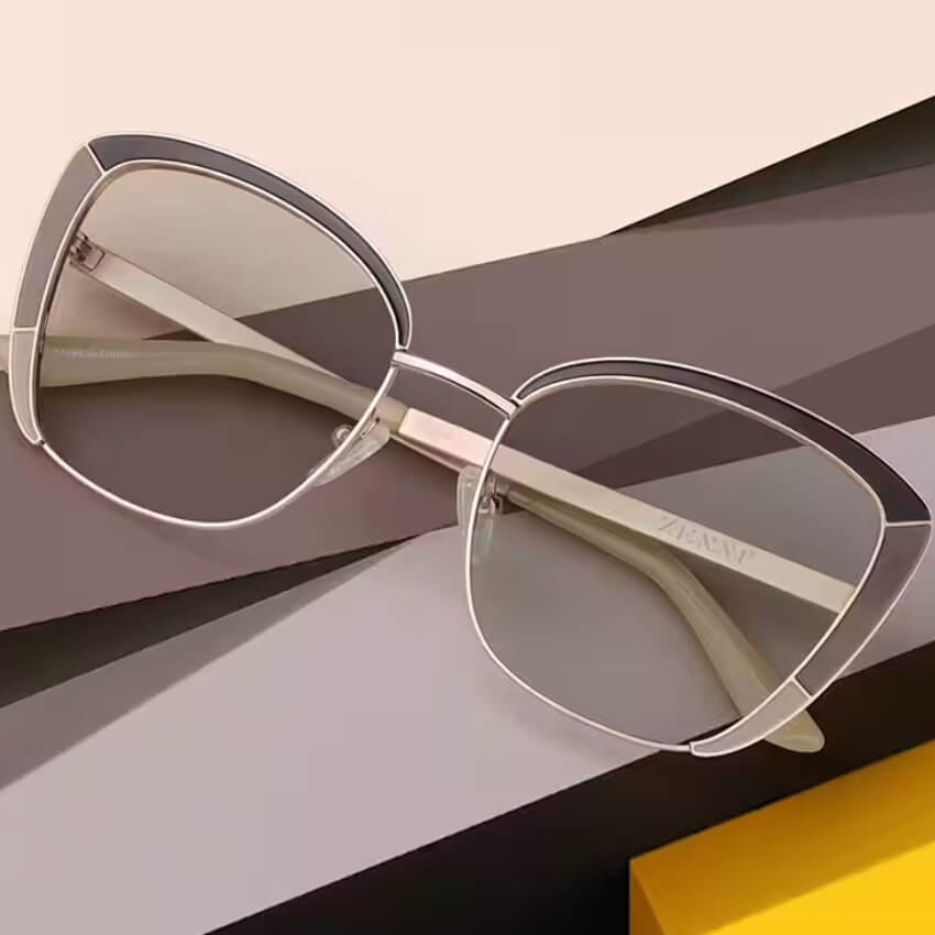 Cat-eye glasses with metal frames, semi-translucent lenses, and the text "ZENNI" on the temple.