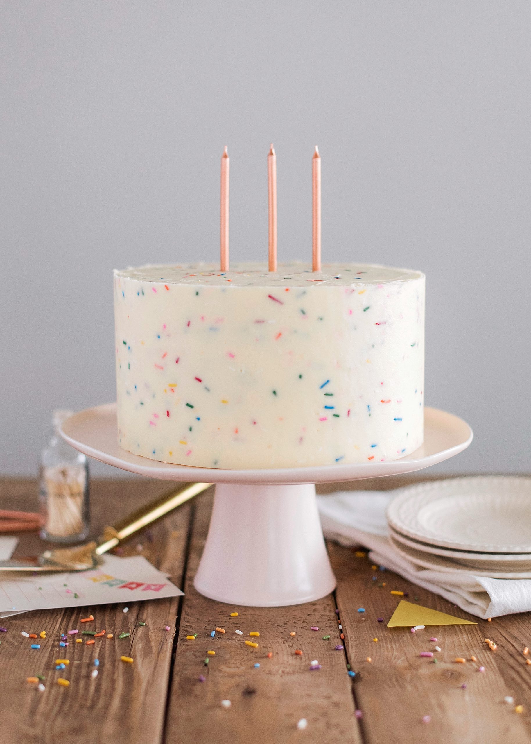 Classic Confetti Cake - tender and fluffy vanilla cake layers, filled with sprinkles and covered with a whipped vanilla buttercream. #confetticake #birthdaycake #bestbirthdaycake #funfetticake #birthdaycakerecipe #vanillabuttercream #cakebycourtney