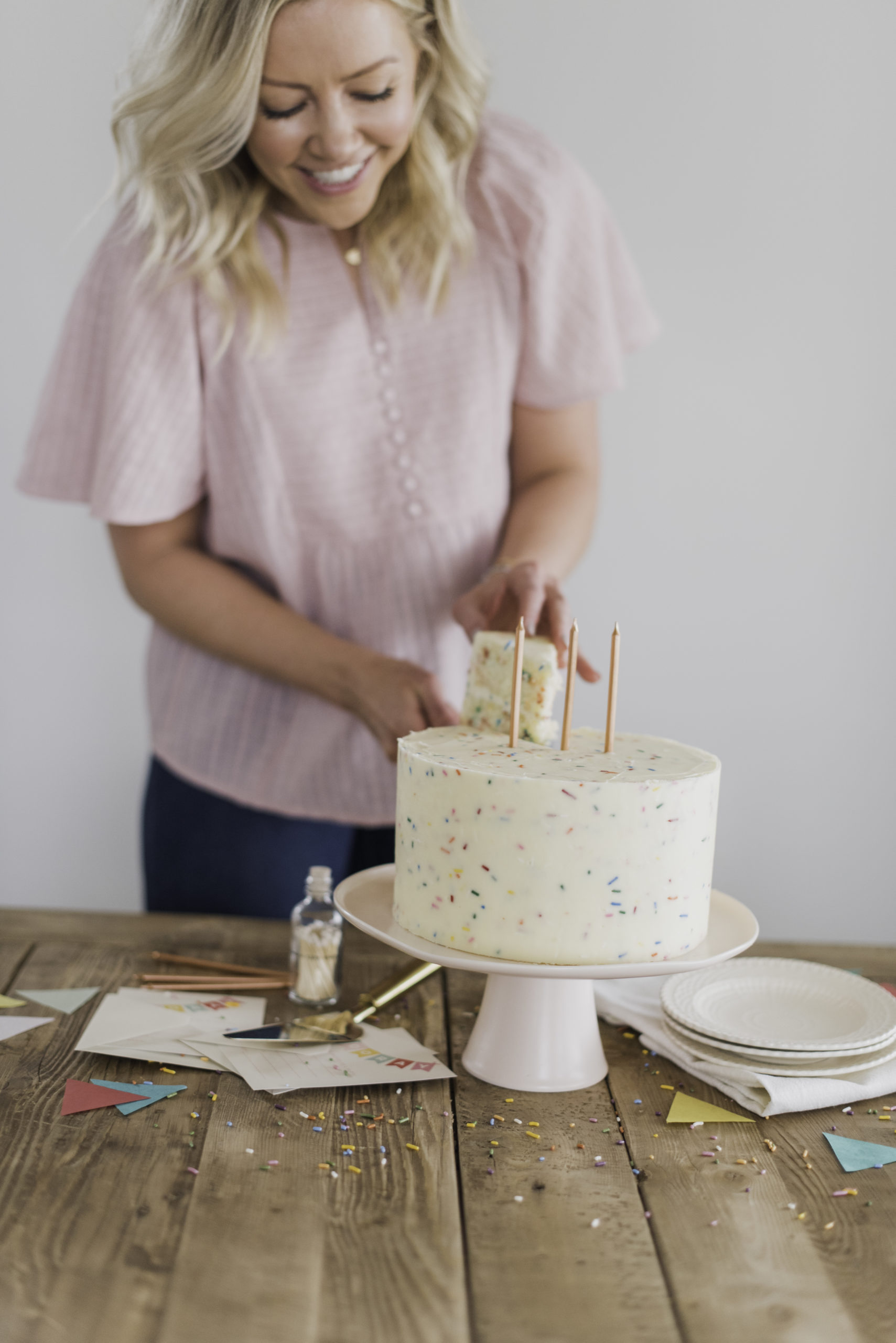 Classic Confetti Cake - tender and fluffy vanilla cake layers, filled with sprinkles and covered with a whipped vanilla buttercream. #confetticake #birthdaycake #bestbirthdaycake #funfetticake #birthdaycakerecipe #vanillabuttercream #cakebycourtney