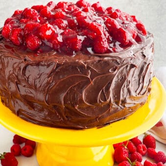 Easy Chocolate Raspberry Cake With Ganache Frosting on Yellow Cake Stand