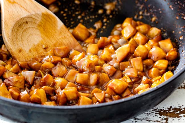 showing how to make easy caramel apple pie by adding caramel to filling